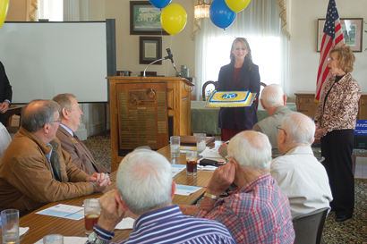 Debra Smith of Sunbelt Ford and Dr. Babs Thomas, Superintendent of the Worth County Board of Education present the local Kiwanis Club with a cake before leading the group in singing Happy Birthday, as the local club celebrated its 90th anniversary last Wednesday.