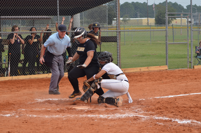 Catcher Lindsey Toneygay tags Valdosta base runner at the plate while the home plate umpire watches closely.