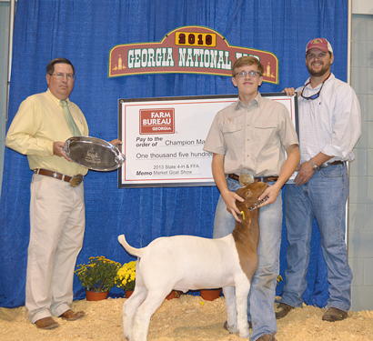 Georgia Farm Bureau Young Farmer Coordinator Jed Evans, right, presents the prize check to Roberts as Chad Coburn, left, who judged the show, presents Roberts a silver platter.