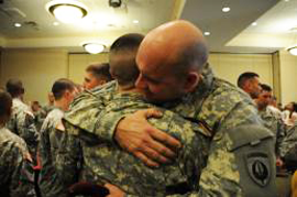 Staff Sgt. Joseph Simms and Pvt. Charlie Shaw share a hug following the Combat Skills Enlisted Green Platoon graduation ceremony, Feb. 18 at Fort Campbell, Ky.